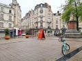 Street with bikes and a statue in the city of Angers, France