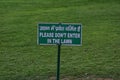 Street Boards in green Backgrounds words in white color text is please Dont Enter in the Lawn both English and Hindi Language