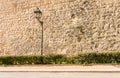 Street bsckground with vintage street lantern and old stone wall. Royalty Free Stock Photo