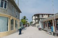 Street with buildings, bikes and people during sunny day at the tropical island Maamigili