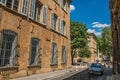 Street with buildings and fountain, sunny afternoon in Aix-en-Provence.