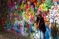 Street Busker performing in front of John Lennon Graffiti Wall