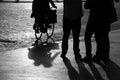 Street bystanders and a cyclist in silhouette