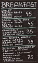 Street cafe breakfast menu written in chalk on a blackboard Royalty Free Stock Photo