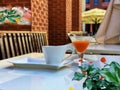 street cafe cup of coffee and glass of juice on table top summer flowers and plant leaves urban  modern design Royalty Free Stock Photo