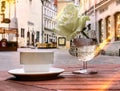 Street cafe cup of coffee and white roses on glass under rain Tallinn old town rainy weather Royalty Free Stock Photo