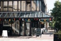 Street cafe in a modern black building in a sunny day