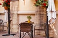 Street cafe in old town. Empty tables and chairs. Autumn city view. Vintage style, trendy neutral colors. Royalty Free Stock Photo