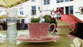 Street Cafe in old town of Tallinn ,Estonia 10,08,2019, table cup of coffee and pink flowers pink coral tablecloth on the table an