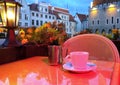 Street cafe  restaurant table cup of coffee on top view candle lamp  light reflection on glass  summer night in the city  holiday Royalty Free Stock Photo