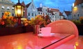 Street cafe  restaurant table cup of coffee on top view candle lamp  light reflection on glass  summer night in the city  holiday Royalty Free Stock Photo