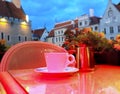 Street cafe  restaurant table cup of coffee on top view candle lamp  light reflection on glass  summer night in the city  holiday Royalty Free Stock Photo