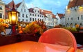 Street cafe restaurant table view candle lamp light reflection on glass summer night in the city holiday