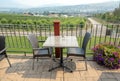 Street cafe table and chairs with smoky Okanagan valley overview