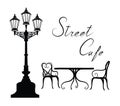 Street cafe - table, chairs, streetlight and lettering City life Royalty Free Stock Photo