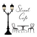 Street cafe - table, chairs, streetlight and lettering City life Royalty Free Stock Photo