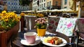 Street Cafe Tables chairs with cup of coffee Flowers City lifestyle Summer Day In Old Town Of Tallinn travel and tourism To Est