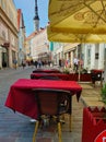 Street Cafe Tables chairs with cup of coffee Flowers City lifestyle Summer Day In Old Town Of Tallinn travel and tourism To Est