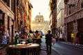 Street cafe with tourists, city life in the center of Rome, Italy