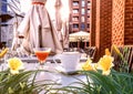 Street cafeteria  cup of coffee and glass of juice on table top summer flowers and plant leaves urban  modern design Royalty Free Stock Photo