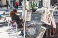 Street caricaturist painter working at La Rambla street. Las Ramblas is one of the most famous streets in the city Royalty Free Stock Photo