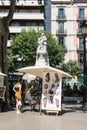 Street caricaturist painter working at La Rambla street. Las Ramblas is one of the most famous streets in the city