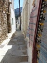 Street with carpets on the wall in a village inland Naxos in Greece.