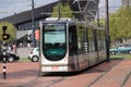 Street cars Trams of the RET in Rotterdam on the streets type Citadis in the Netherlands with buildings and scyscraper