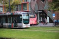 Street cars Trams of the RET in Rotterdam on the streets type Citadis in the Netherlands with buildings and scyscraper