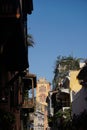 Street in Cartagena with the Cloister of St. Augustine campus bell tower in the background, Colombia