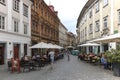 Street in the center of Ljubljana and several tourists passing by