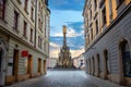 Street in centre city with view to square and monument of Holy Trinity Column. Olomouc, Czech Republic Royalty Free Stock Photo