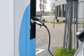 street, charging with electricity through cable, electric vehicle in European city, eMobility charging,energy accumulators,