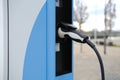 street, charging with electricity through cable, electric vehicle in European city, eMobility charging, energy accumulators,