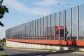 Street in the city built of transparent walls limiting the noise