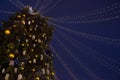 Street city Christmas tree at night. The garlands are burning. Holiday decorations and toys. Garland of lights. Royalty Free Stock Photo