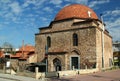 A street of the city with the Murat Hamami public bath building against a blue sky with clouds in Iznik