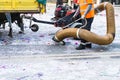 Street cleaner with industrial vacuum cleaner. Municipal cleaning service, clean streets. Royalty Free Stock Photo