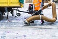 Street cleaner with industrial vacuum cleaner. Municipal cleaning service, clean streets. Royalty Free Stock Photo