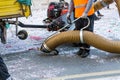 Street cleaner with industrial vacuum cleaner. Municipal cleaning service, clean streets. Royalty Free Stock Photo