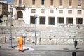 Street cleaner near the ancient Roman amphitheater