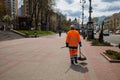 Street Cleaner With A Recognizable Orange Jacket That Cleans The Street