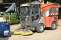 Street cleaner vehicle and garbage can on the road Royalty Free Stock Photo