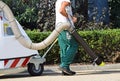 Street cleaner works with a vacum cleaner Royalty Free Stock Photo