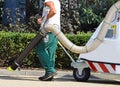 Street cleaner works with a vacum cleaner Royalty Free Stock Photo