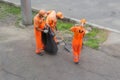 Street cleaners sweeping sidewalk