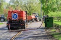 Street cleaning sweeper machines pumping water for washing asphalt road Royalty Free Stock Photo