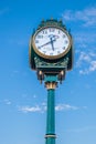 Street clock, clock on a pole at the blue sky background. Vintage street clock on a wooden pole in Nanaimo BC Canada