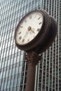 Street clock in front of a glass skyscraper Royalty Free Stock Photo