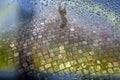 Street with cobble stones and puddle after rain seen through wet window pane Royalty Free Stock Photo